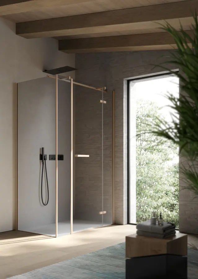 Brushed brass shower enclosure with frameless hinged door