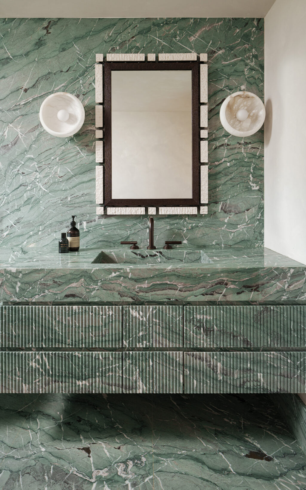 Bathroom vanity with green marble and dark bronze three hole tap modern