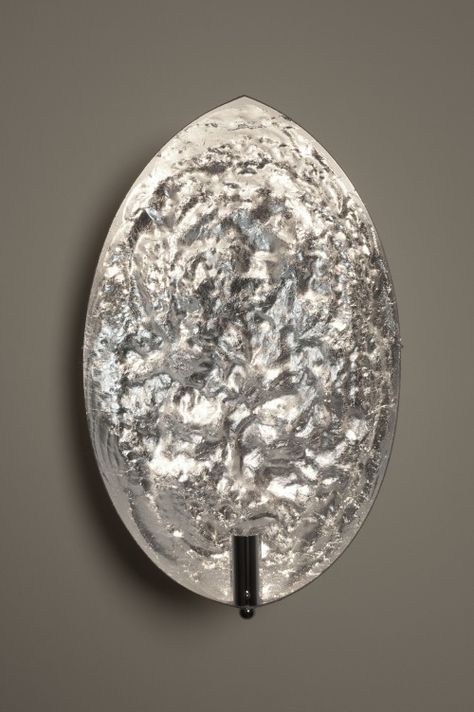 Decorative wall sconce with textured glass shade