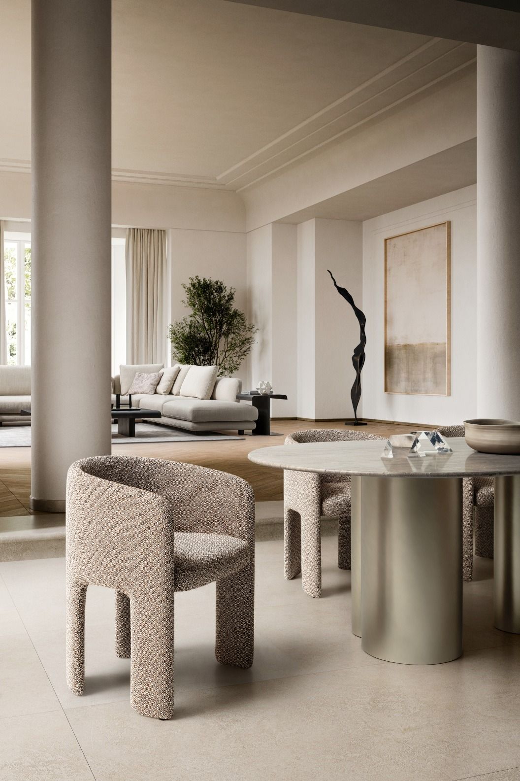 Modern interior with a round dining table and chairs in a neutral color palette.