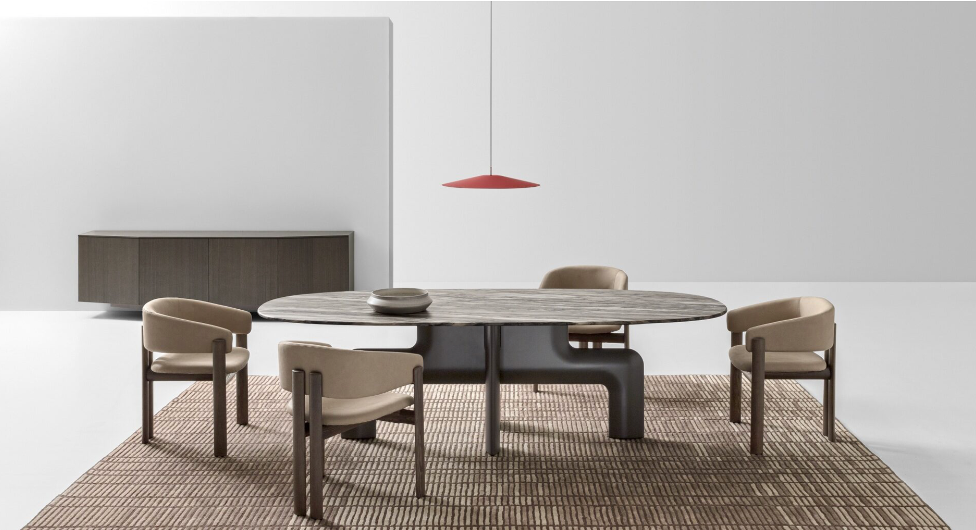 Dining room with a round table and chairs in a modern interior setting.