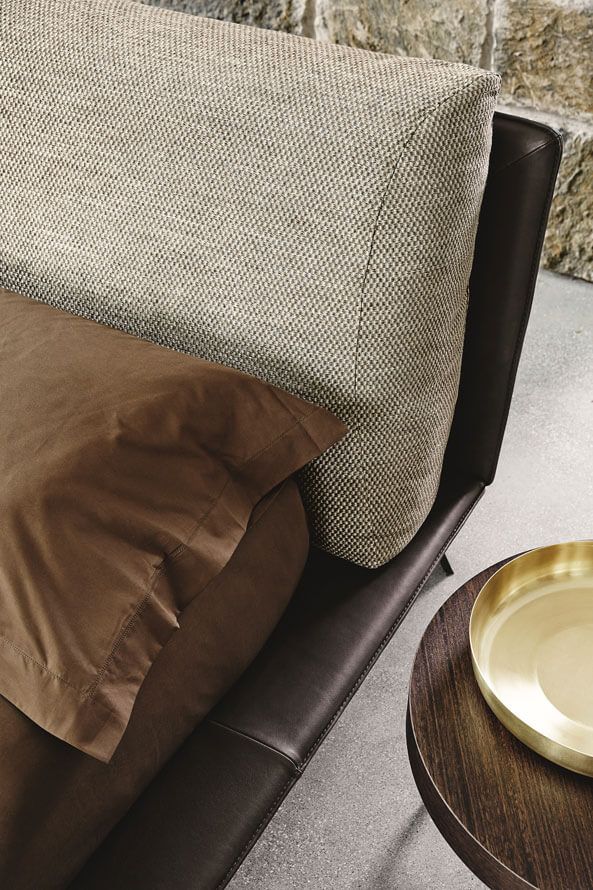 Brown chair with textured cushion and gold plate on a wooden table