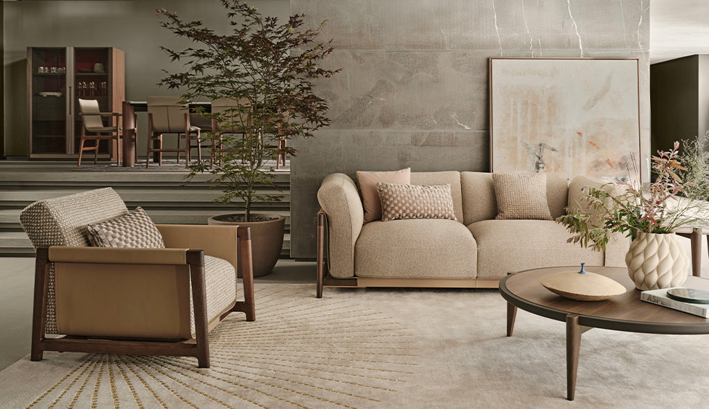 Modern living room with beige sofa, armchair, and coffee table.