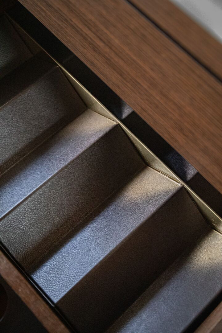 Close-up of a dark brown leather drawer organiser 