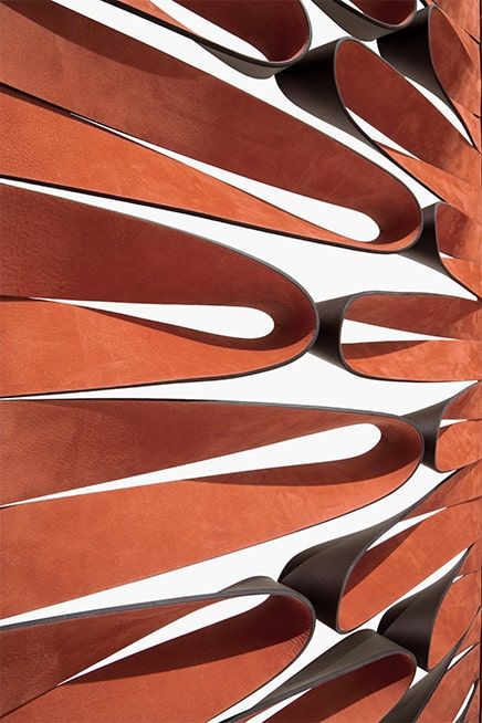 Close-up of brown leather straps arranged in a pattern