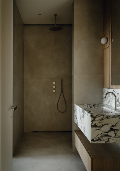Modern bathroom with marble countertop and shower area