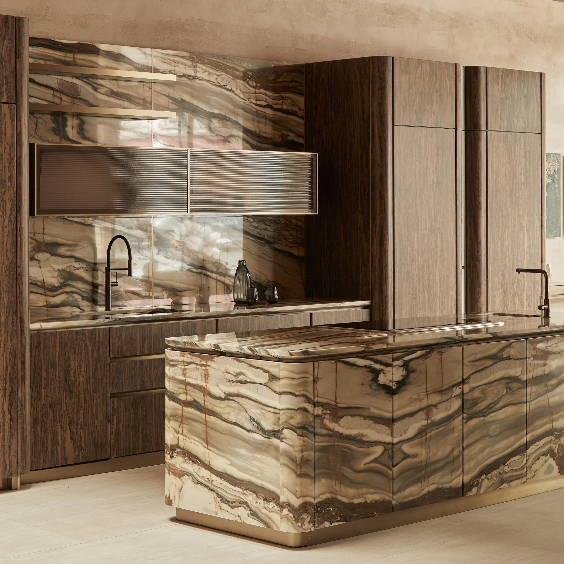 Modern kitchen with marble island and wood cabinets with brass details 