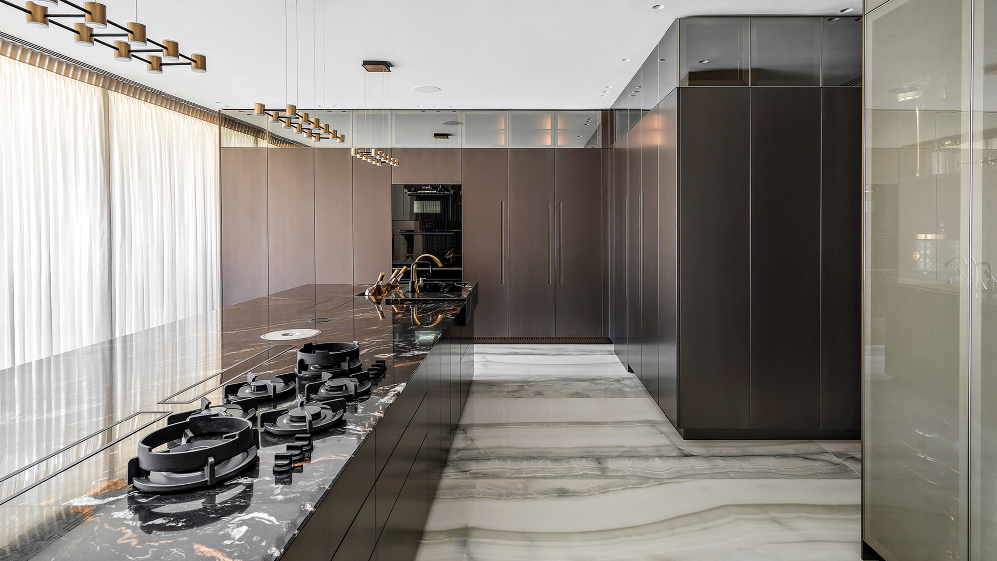 Modern kitchen with marble countertop and stainless steel appliances