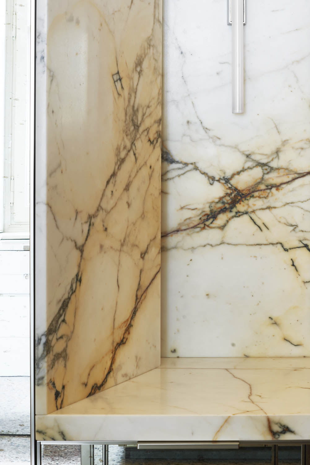 Marble-patterned kitchen cabinets with a neutral color scheme.
